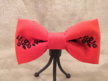 Red bow with black flower vine