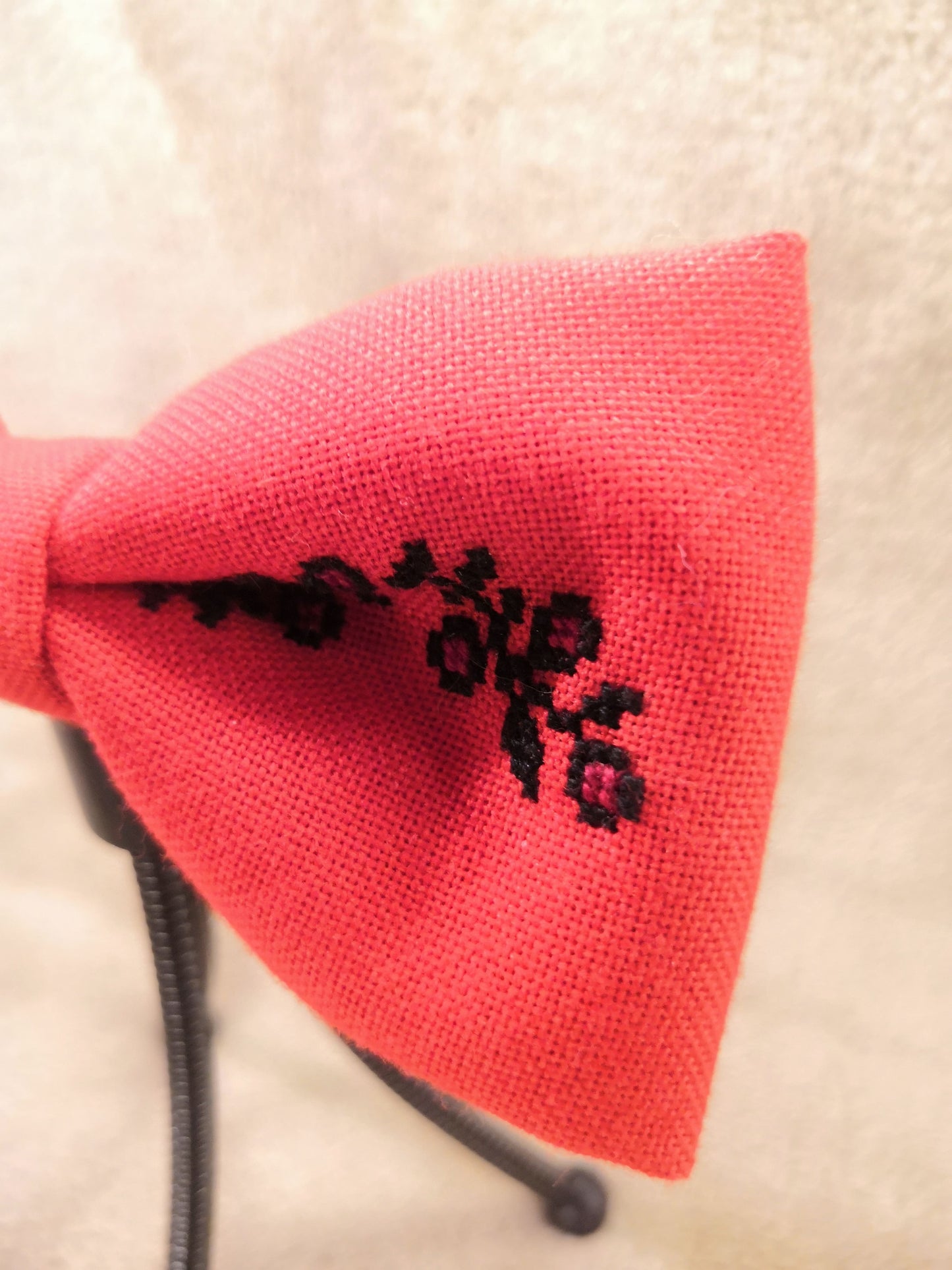 Red bow with black flower vine