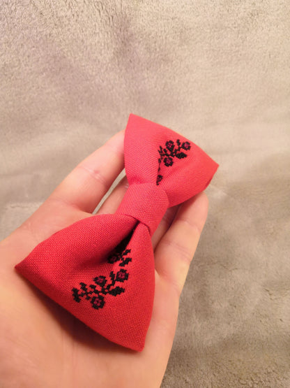 Red bow with black flower vine