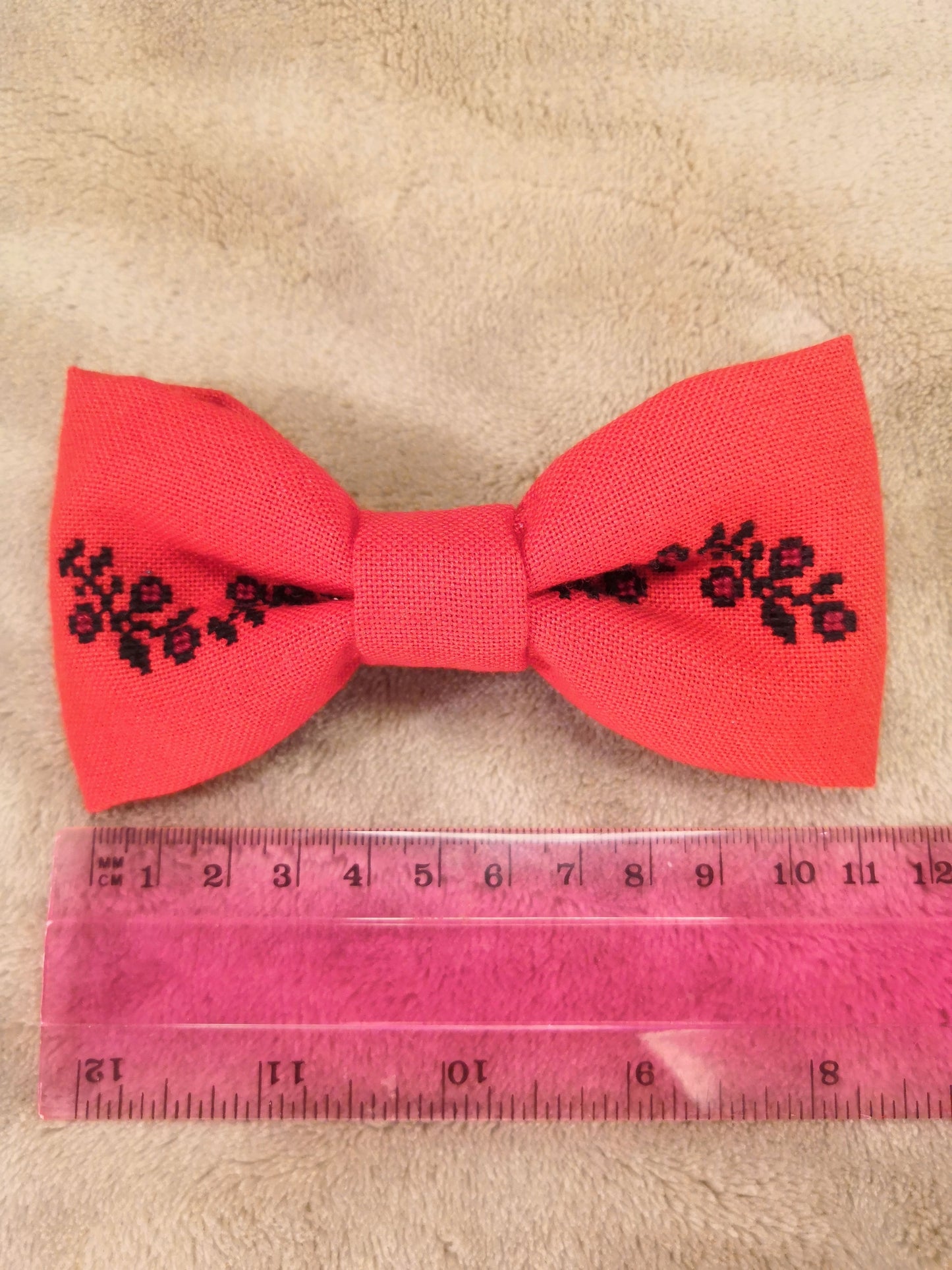 Red bow with black flower vine