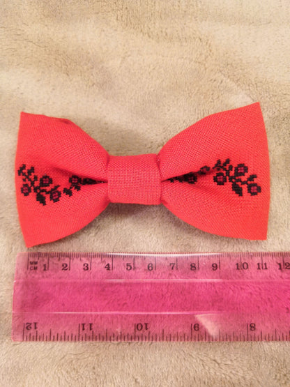 Red bow with black flower vine