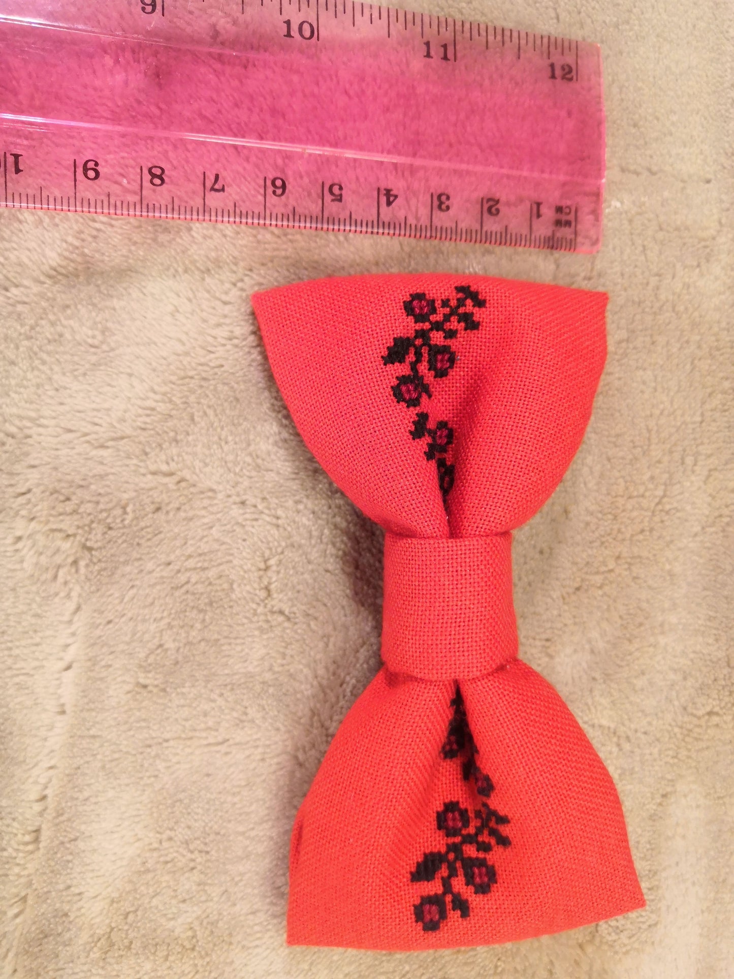Red bow with black flower vine
