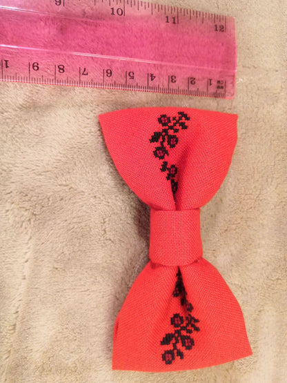 Red bow with black flower vine