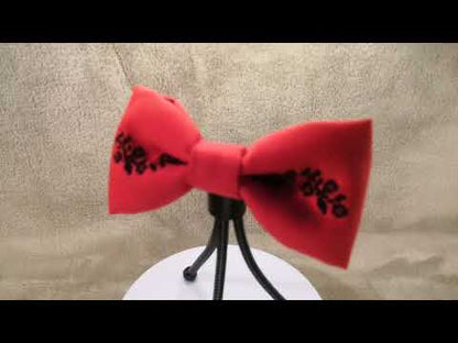 Red bow with black flower vine